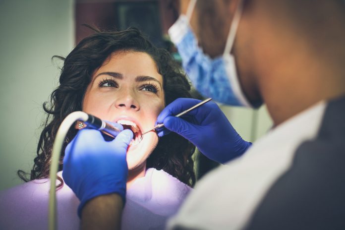 Woman on dentist surgery. Close up.