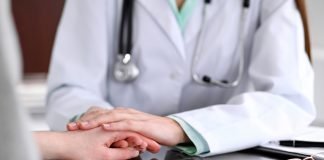 Combination Treatment of Ianalumab + Ibrutinib May Help Some Patients to Discontinue Daily Therapy A friendly doctor holding a patient's hand sitting at her desk for encouragement, empathy and support following a medical examination.