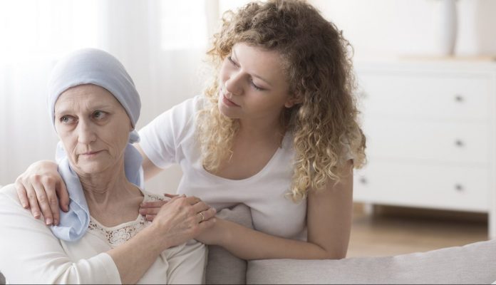 Caregiver supporting sick cancer patient